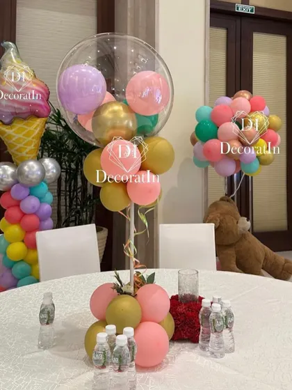 Another view of the balloon centerpieces, with a giant ice cream cone prop in the background.
