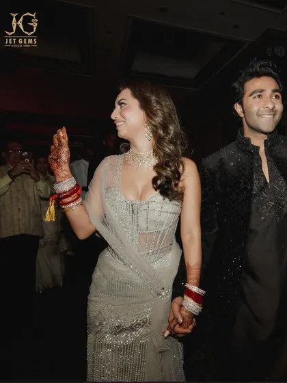 A beautiful moment of celebration, with the bride glowing in her classic diamond necklace set.