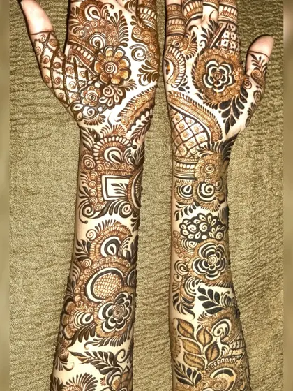 A full-arm Indo-Arabic design that is packed with detail. From the wrists to the fingertips, every space is filled with beautiful patterns like paisleys, florals, and geometric shapes.