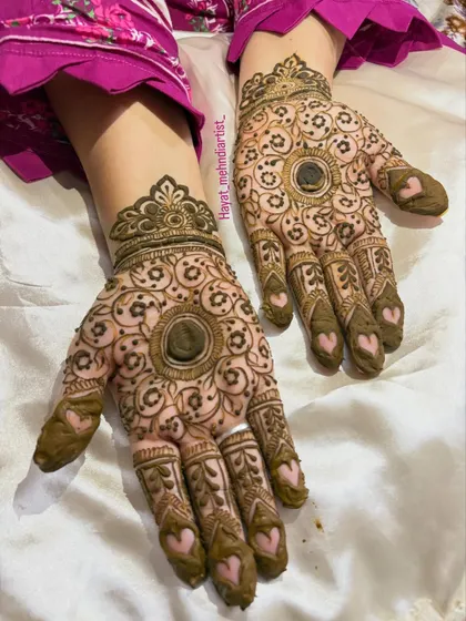 Who says you can't have a little fun with your mehndi? I love adding cute details like these little hearts on the fingertips to a traditional mandala design. It's a modern twist on a classic look.