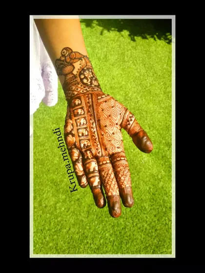 A beautiful example of a full-hand bridal design after the henna paste has been removed, revealing a promising orange stain that will darken over time.