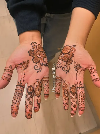 A minimal design for an engagement, with a simple floral motif on the palm and detailed fingers.