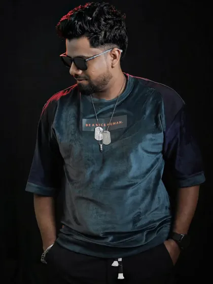 A portrait shot showcasing a modern, stylish look. Fashion is part of the performance.