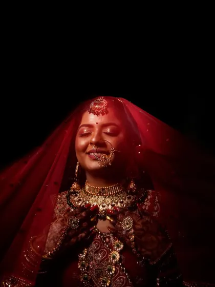 The moment a bride is lost in her own thoughts, just before the ceremony begins. I used dramatic lighting to highlight the rich red of her veil and the intricate details of her bridal jewellery, creating a timeless and soulful portrait.