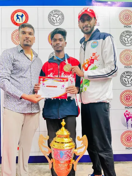 Celebrating a gold medal win with one of our young and promising kickboxers. His hard work in the gym paid off in the competition.