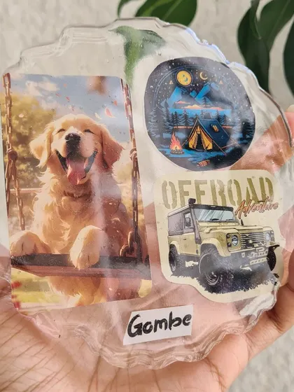 A custom resin coaster made for a dog lover, featuring a happy photo of their golden retriever "Gombe" and some adventure-themed stickers. It's a daily reminder of happy moments.