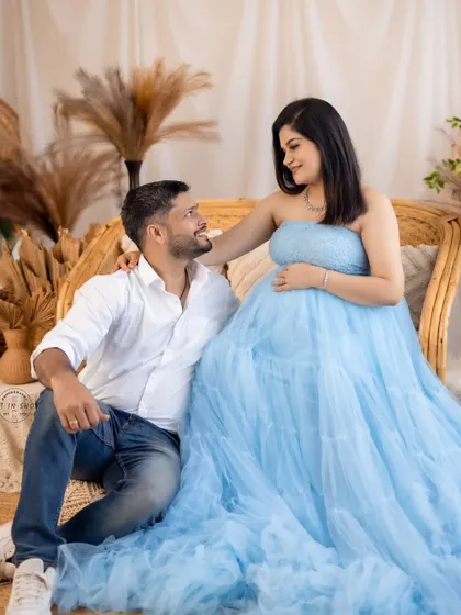 A sweet and relaxed couple's portrait, capturing a shared smile and the excitement of their journey to parenthood.