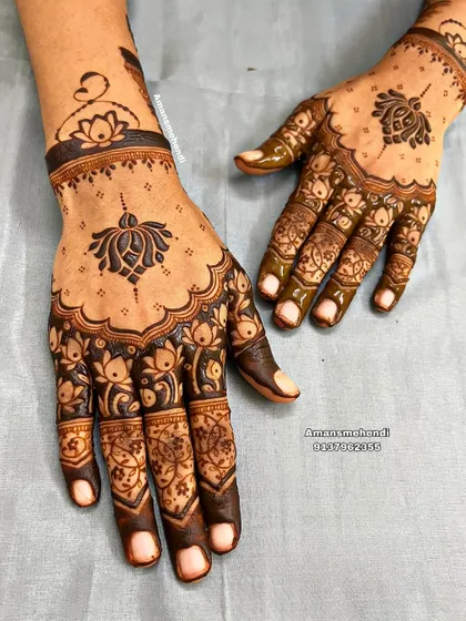 A beautiful back-of-hand design featuring lotus motifs. The pattern is light and open, perfect for someone who prefers a less dense mehndi look.