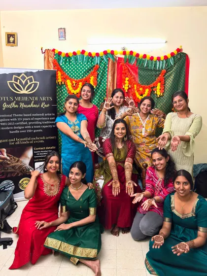 A wonderful group photo with the bride and all her guests, everyone showing off their beautiful mehendi from my team.