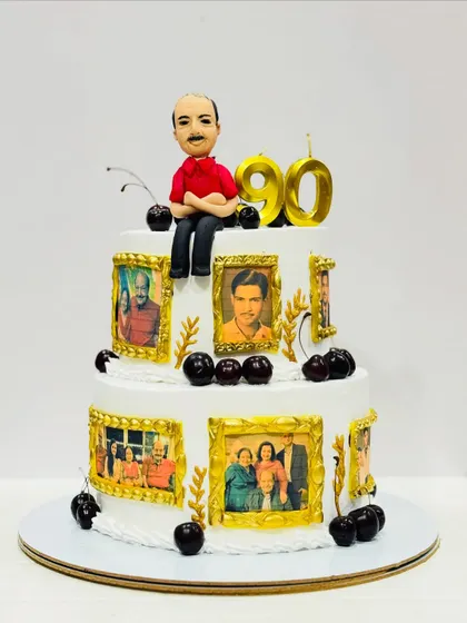 A memory-lane cake for a 90th birthday. This two-tier cake is decorated with edible photo frames showing pictures from the person's life, topped with a custom caricature.