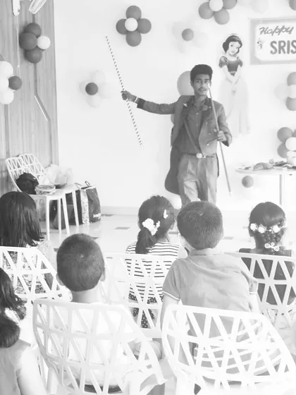 Performing for an attentive audience of children at a birthday party for Srishti. My shows are structured to keep kids engaged from start to finish with visual tricks like the classic magic wand.