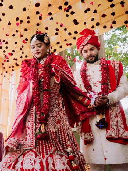 The couple during their 'Varmala' ceremony, showered with petals.