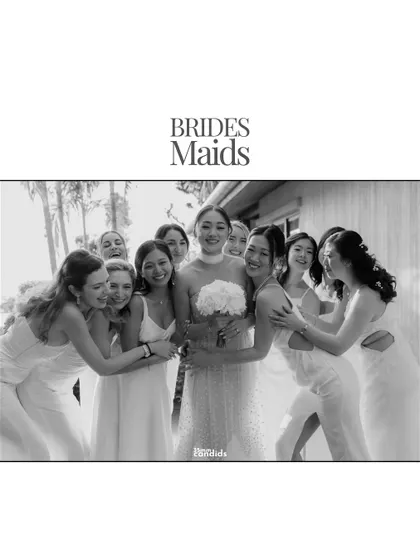 A joyful, black and white group hug between the bride and her bridesmaids. A perfect capture of sisterhood and celebration.