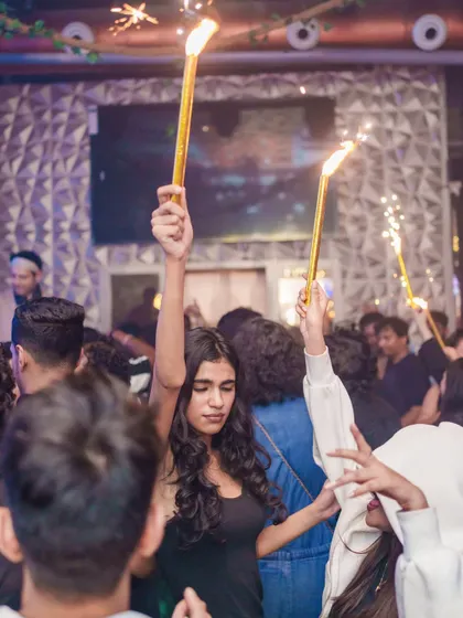 The crowd celebrating with sparklers at Happy Brew, making the night feel extra special.