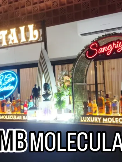 A multi-station bar featuring dedicated areas for 'Cocktails' and 'Sangria', each with its own distinct neon sign and setup.