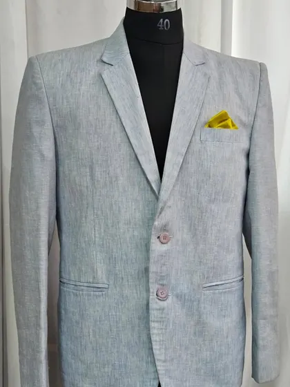 A classic light grey linen blazer, perfect for a daytime event or a relaxed pre-wedding photoshoot.