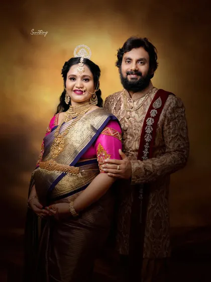 A regal portrait of a couple in traditional attire. The rich fabrics, ornate jewelry, and classic studio lighting create a majestic and timeless image celebrating their heritage.
