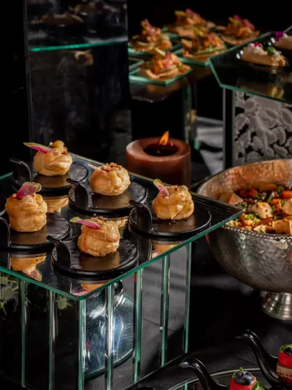 Cream puffs served on mirrored platters at a Diwali party. The elegant presentation and delicious flavor make these a favorite among guests.