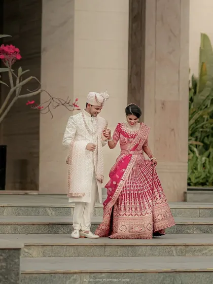 A beautiful shot of the couple walking down the steps of the Sheraton Grand. The bride's flowing lehenga and their happy expressions make for a perfect portrait.