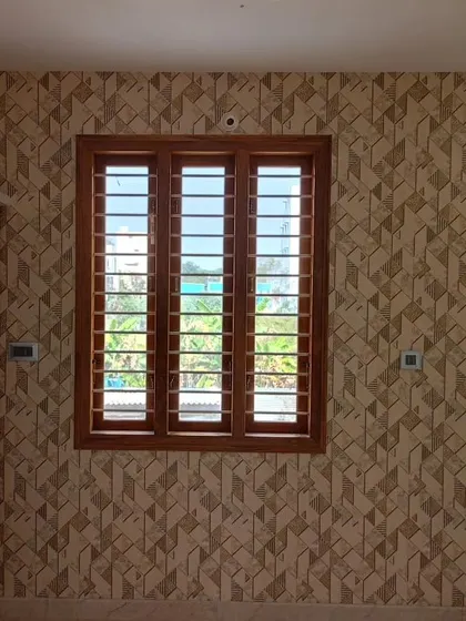 A 3D geometric wallpaper in brown tones installed in a bedroom.