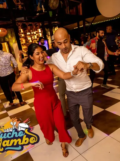 A couple shares a happy moment while dancing. The positive energy at our events is perfect for unwinding after a long week.