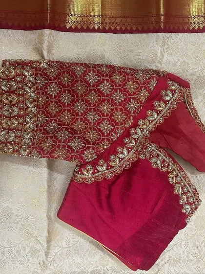 Another angle of the red bridal blouse, highlighting the intricate patterns and the quality of the handwork.