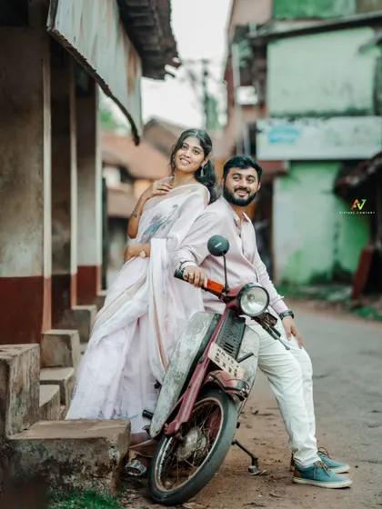 A playful and stylish pre-wedding photo with the couple posing on a vintage scooter, blending retro vibes with modern romance.