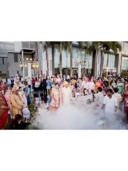 A wide shot of the grand entrance at the 50th-anniversary celebration, with smoke effects creating a magical atmosphere.