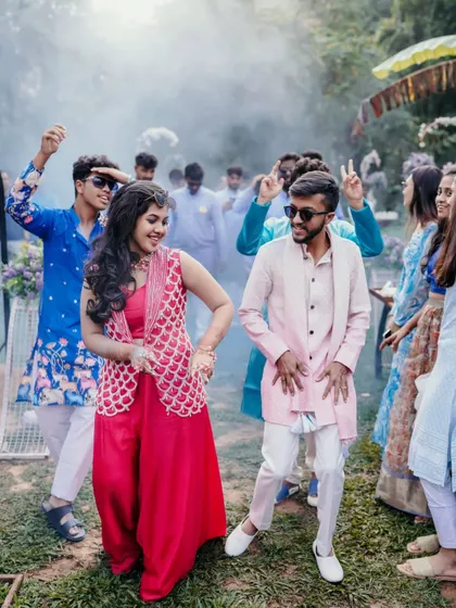 The couple and their friends dancing with smoke effects, capturing the high energy of the party.