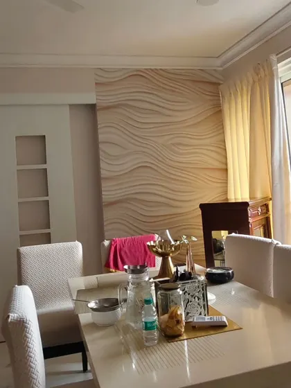 An accent wall with a wavy, sand-dune-like 3D texture. This adds a natural, organic feel to the dining space.