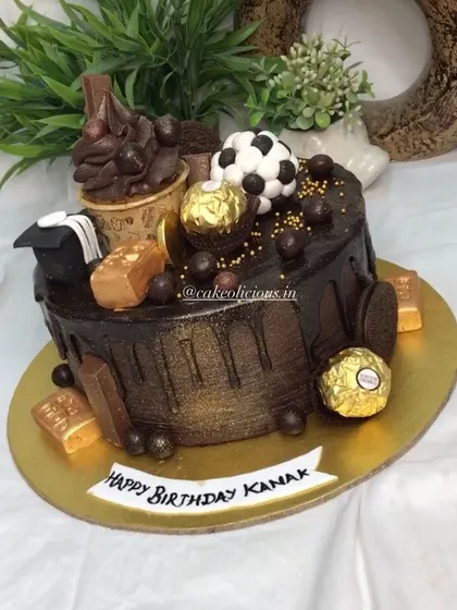 An overloaded chocolate cake for a football lover. This ganache drip cake is topped with Ferrero Rocher, a mini cupcake, and other chocolatey treats.