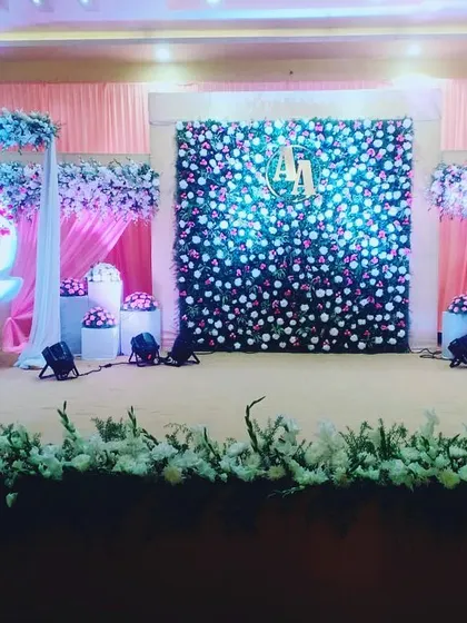 We design the entire stage to complement the naming ceremony's main features. Here, the floral swing is balanced by a custom flower wall and decorative elements, creating a harmonious and grand setting.