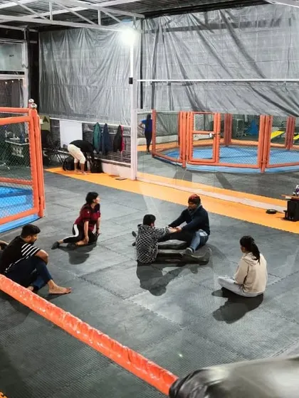 After the hard work, there's always time for community. Members relax and chat on the mats at our Noida Extension club.
