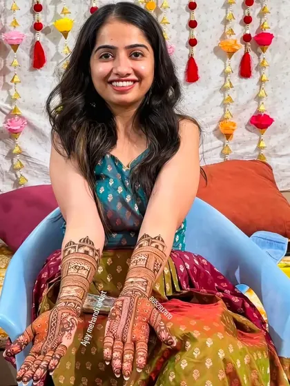Another shot of the happy bride, her smile as bright as her beautiful mehndi.