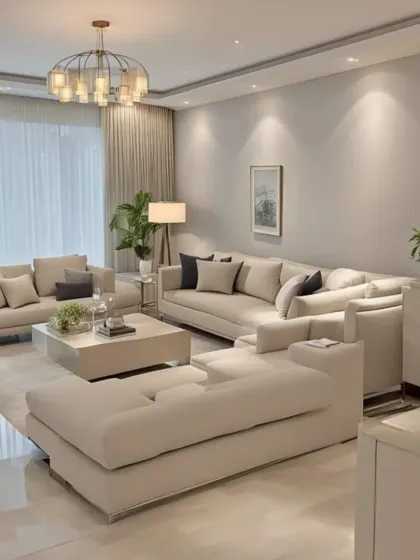 A duplicate of ID 68, this image shows a spacious living room with a light, neutral color palette creating a calm and sophisticated environment. The large sectional sofa offers plenty of seating, making it an ideal space for social gatherings.