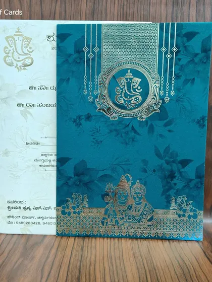 This teal invitation featuring Ganesha and a depiction of Shiva and Parvati, ideal for a blessed union.
