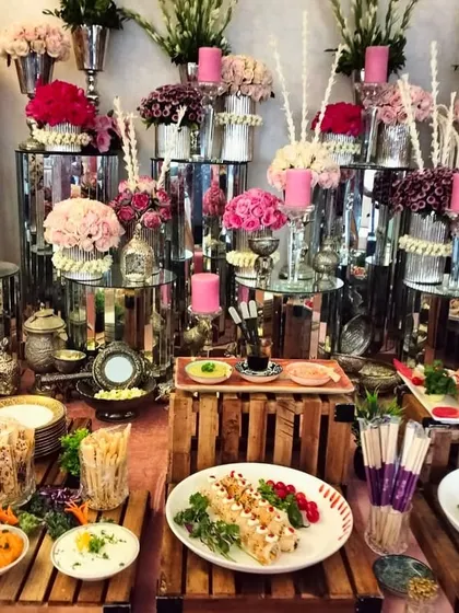 Table settings of our dreams! This lavish spread features a stunning array of pink florals, silverware, and our most popular appetizers, creating a truly opulent atmosphere.