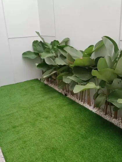 Another example of a simple yet effective use of artificial turf in a tight space. This solution provides a patch of green that is perfect for pets or as a visual break from hard surfaces, with zero upkeep required.