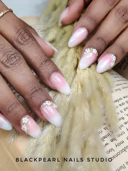 Here is a classic baby boomer nail set, enhanced with delicate floral designs made from tiny beads on the accent fingers. This design is a favorite among brides for its romantic and sophisticated feel, offering a timeless look with a touch of texture.