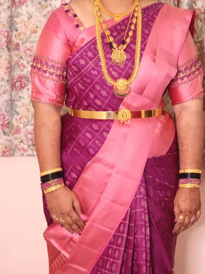 Saree draping is an art. Here is a perfectly pleated Kanchipuram silk saree, ensuring the client looks elegant and feels comfortable throughout her event.
