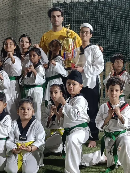 A group of my students posing in their fighting stance with a championship trophy. They are all champions in my eyes.
