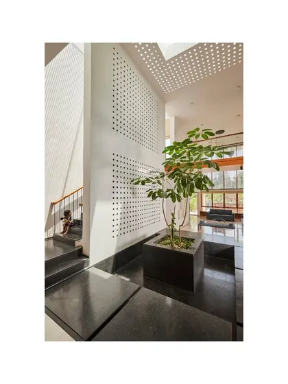 Another angle of the Vikas Residence courtyard, showing the interplay of light and texture.