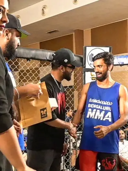 Our fighter, Jitu, receiving his prize after a victorious return to the MMA cage.