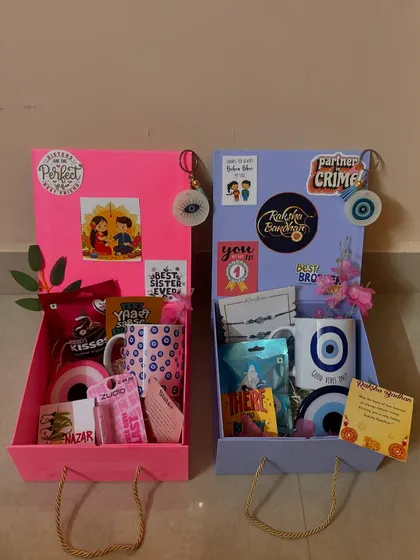 A side-by-side view of the pink and blue Rakhi hampers. They are designed to be a perfect pair, just like the siblings they are for.