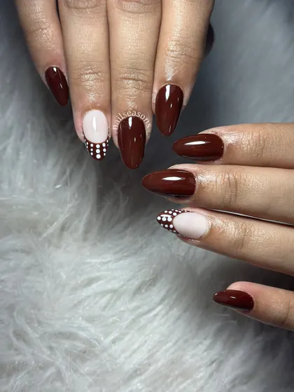Choco glam with a pop of polka dots. A rich brown polish paired with a nude accent nail featuring a fun dot pattern.