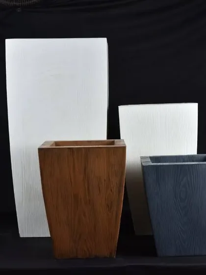A collection of square and rectangular planters with a wood-grain finish. These fiber pots give the look of wood without the weight or risk of rotting.