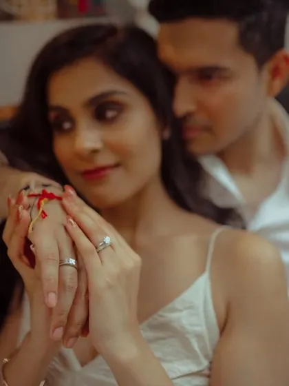 A tender, artistic shot from a pre-wedding session, focusing on the couple's hands and rings, symbolizing their commitment.