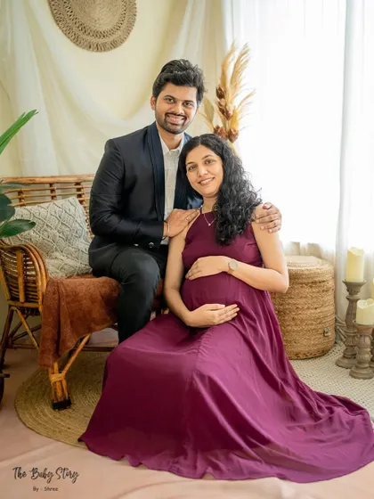 A lovely portrait of the couple seated in the boho setup. Their happy expressions and comfortable poses reflect the relaxed and joyful atmosphere of the session.