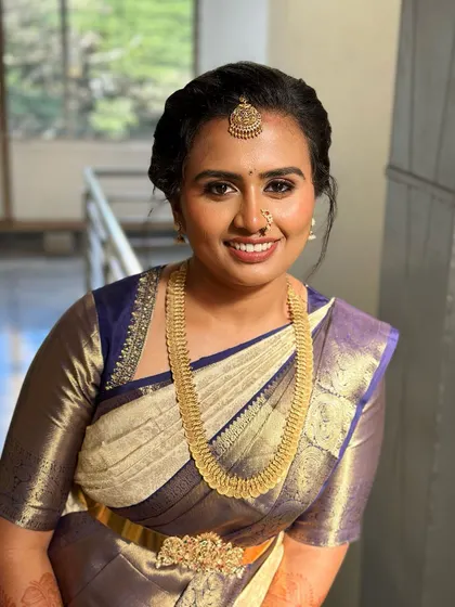 A happy and radiant bride. I created a soft, glowing look that enhances her beautiful smile and complements her classic white and blue silk saree.