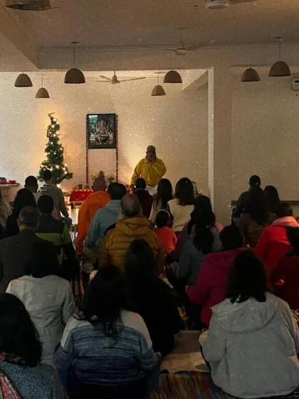 A wide view of our New Year's satsang, with our community gathered to welcome the year with positive intentions. The decorated tree in the background adds a festive, yet serene, touch to our spiritual gathering.